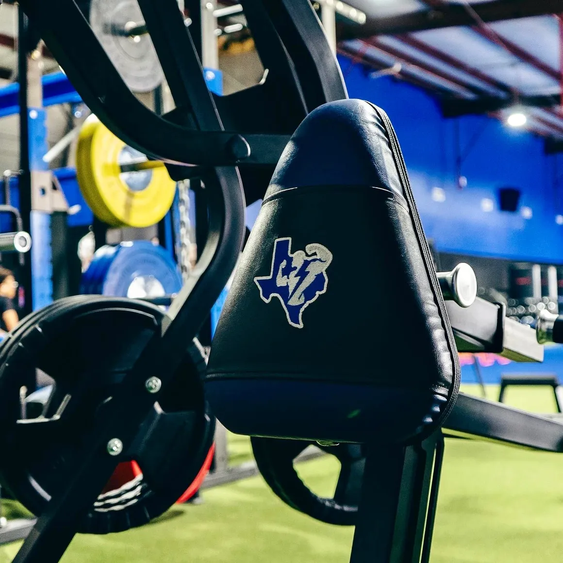Branded Texas Athletics weight bench at the Brittmoore Rd Houston training facility